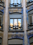 20979 Reflection of chimneys in court yard window La Pedrera.jpg
